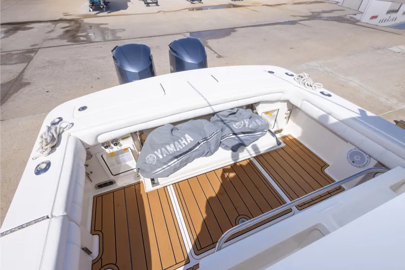 Change Order Yacht Photos Pics 2018 Regulator 31 boat deck with Yamaha engines, featuring teak flooring and white seating.