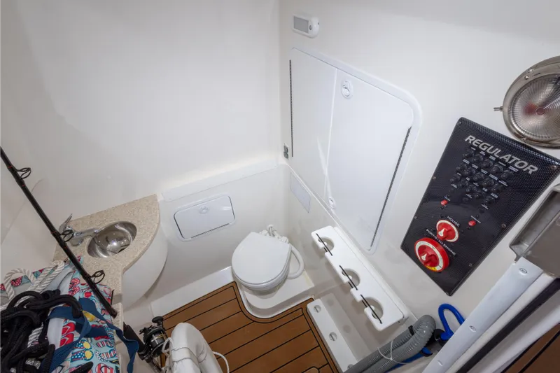 Change Order Yacht Photos Pics 2018 Regulator 31 boat bathroom with sink, toilet, and control panel.