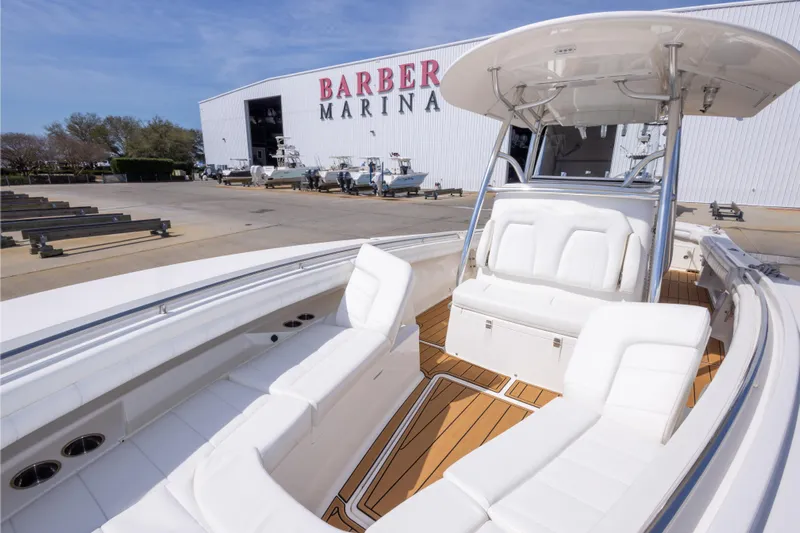 Change Order Yacht Photos Pics 2018 Regulator 31 boat at Barber Marina with white seating and wooden deck.
