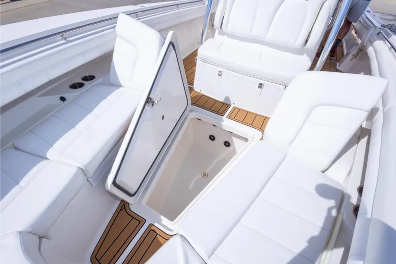 Change Order Yacht Photos Pics 2018 Regulator 31 boat interior with open storage compartment and white seating.