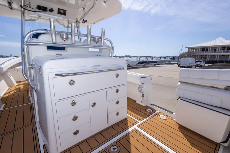 Change Order Yacht Photos Pics 2018 Regulator 31 boat interior with sleek cabinetry and teak flooring at a marina.