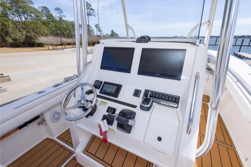 Change Order Yacht Photos Pics 2018 Regulator 31 boat helm with dual screens and modern controls.