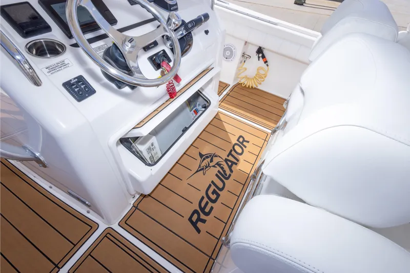 Change Order Yacht Photos Pics 2018 Regulator 31 boat interior with steering wheel and branded flooring.
