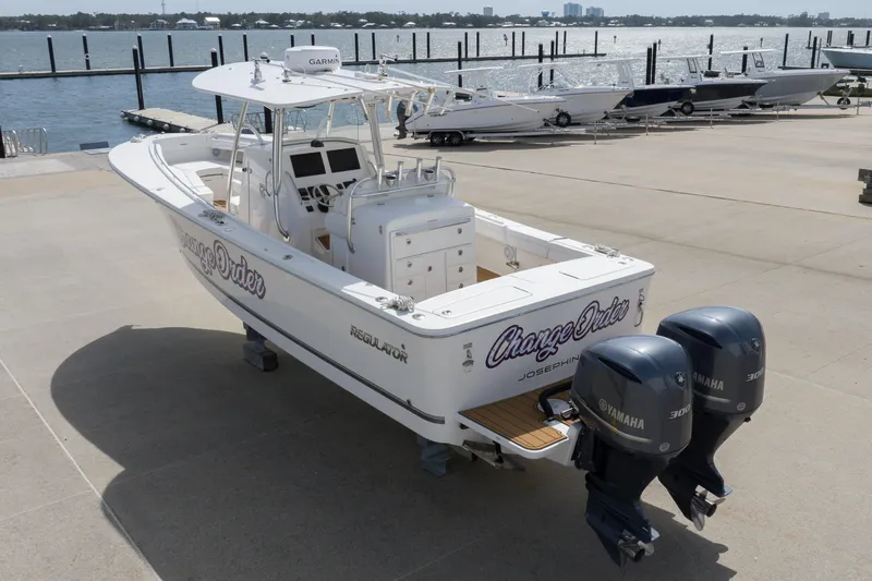 Change Order Yacht Photos Pics 2018 Regulator 31 boat with twin Yamaha engines docked by the waterfront.