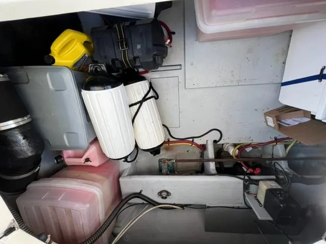 Her Idea Yacht Photos Pics Engine compartment of a 2005 Meridian 381 boat with various equipment and storage containers.