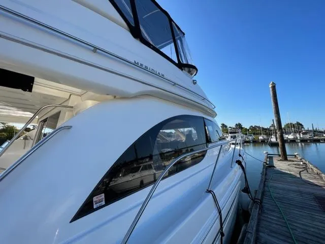 Her Idea Yacht Photos Pics 2005 Meridian 381 yacht docked at a marina on a sunny day.