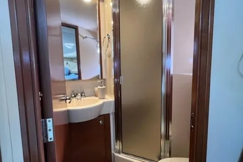 Her Idea Yacht Photos Pics 2005 Meridian 381 yacht bathroom with sink, mirror, and enclosed shower.