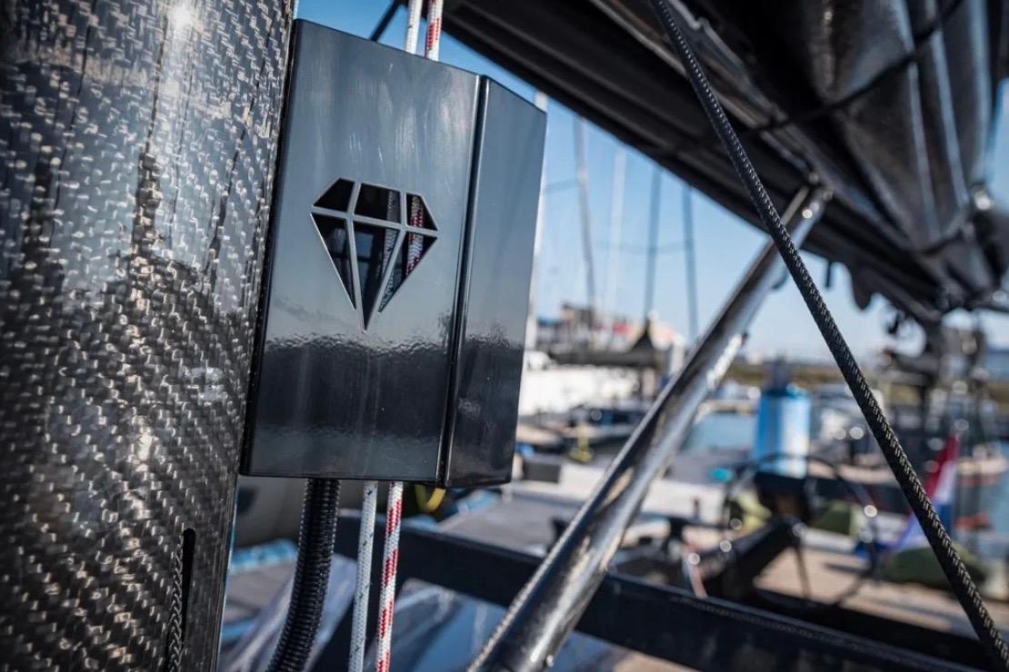 Close-up of 2025 Saffier 33 yacht detail with diamond logo, docked in marina.