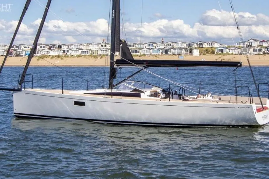 2025 Saffier 33 sailboat on water, coastal homes in background, clear sky.