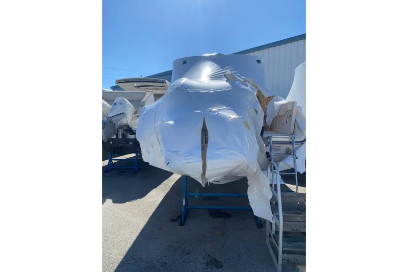  Yacht Photos Pics 2026 Grady-White Freedom 307 boat wrapped in protective covering outdoors.