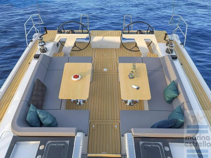  Yacht Photos Pics Luxurious 2022 Hanse 510 yacht deck with seating, tables, and ocean view.
