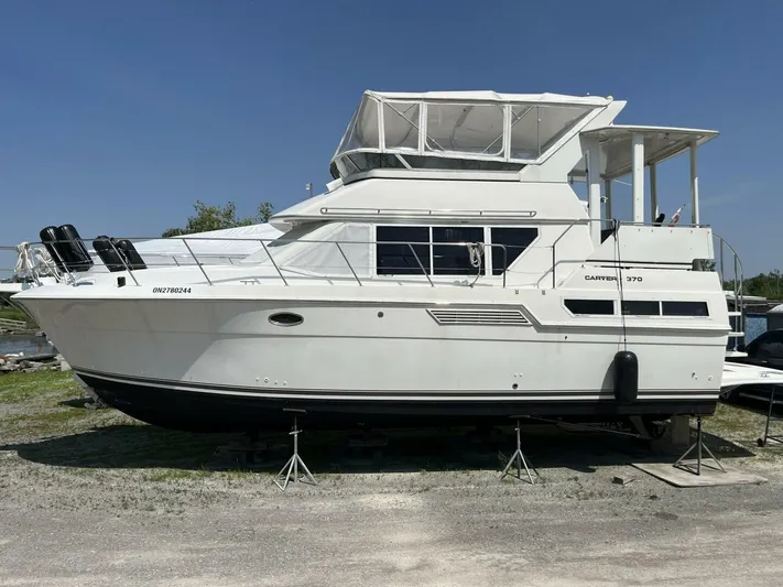  Yacht Photos Pics 1996 Carver 370 Aft Cabin yacht on stands, side view, outdoors, clear sky.