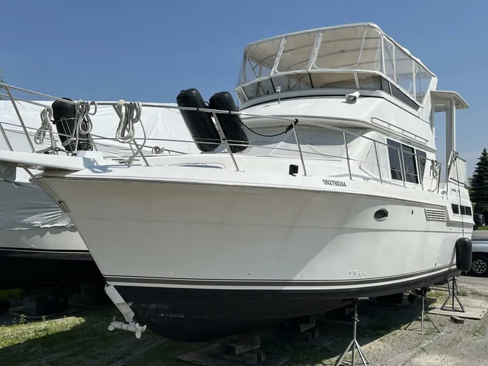  Yacht Photos Pics 1996 Carver 370 Aft Cabin yacht on dry dock, white exterior, clear sky background.