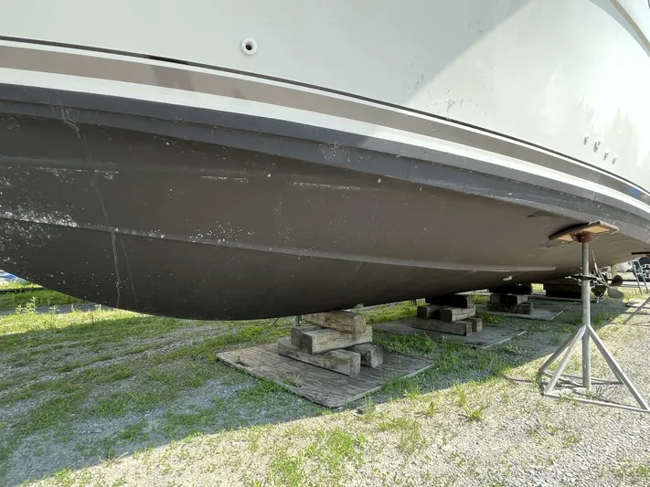  Yacht Photos Pics 1996 Carver 370 Aft Cabin boat hull on dry dock, supported by stands.