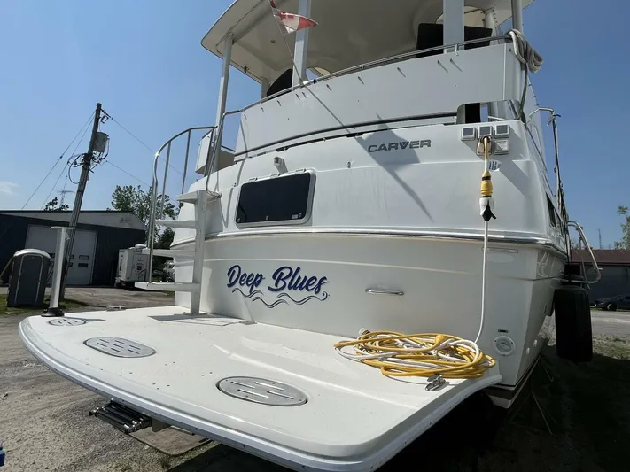  Yacht Photos Pics 1996 Carver 370 Aft Cabin yacht named "Deep Blues" docked with visible stern and deck.