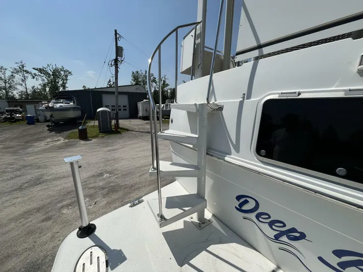  Yacht Photos Pics 1996 Carver 370 Aft Cabin boat with ladder, docked outdoors under clear sky.