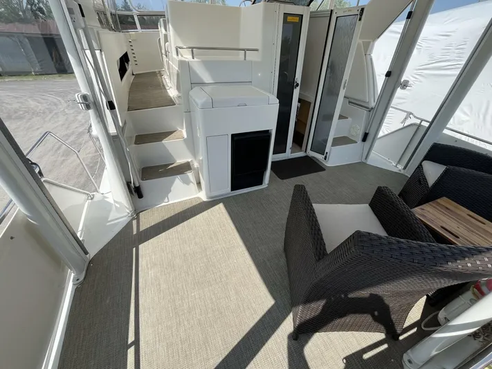  Yacht Photos Pics 1996 Carver 370 Aft Cabin interior with seating and stairs, featuring modern design elements.