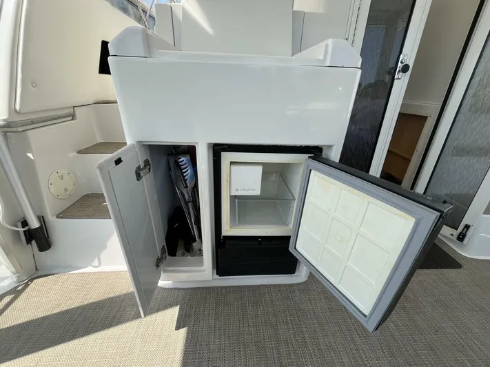  Yacht Photos Pics 1996 Carver 370 Aft Cabin interior with open storage and mini fridge.