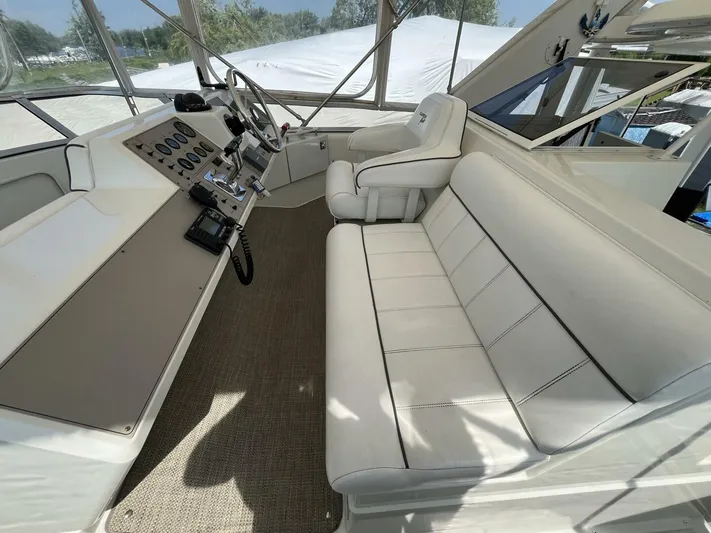  Yacht Photos Pics 1996 Carver 370 Aft Cabin interior with white seating and control panel.