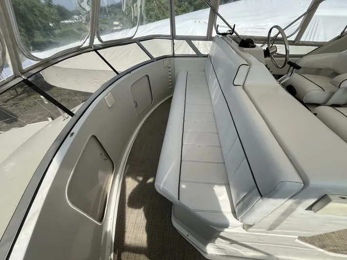  Yacht Photos Pics 1996 Carver 370 Aft Cabin interior with white seating and helm station.