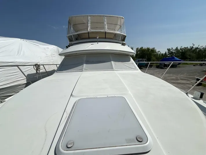  Yacht Photos Pics 1996 Carver 370 Aft Cabin yacht with spacious deck under clear blue sky.