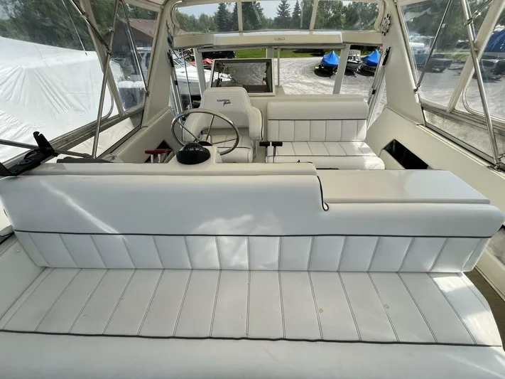  Yacht Photos Pics 1996 Carver 370 Aft Cabin interior with white seating and steering wheel.