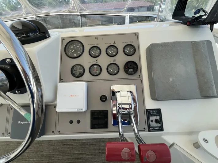  Yacht Photos Pics 1996 Carver 370 Aft Cabin helm with gauges, controls, and steering wheel.