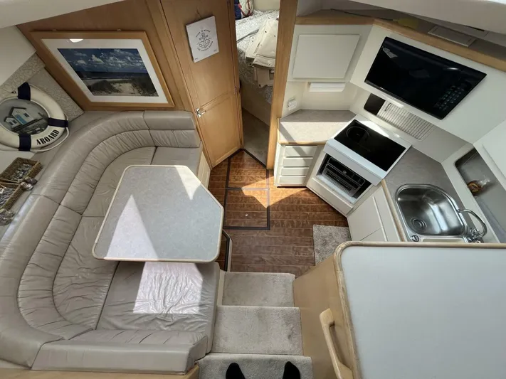  Yacht Photos Pics 1996 Carver 370 Aft Cabin interior with kitchen, dining area, and cozy seating.