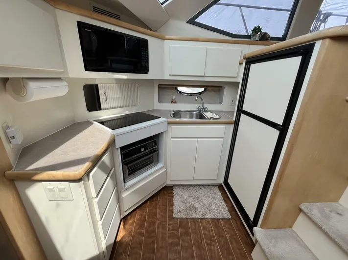  Yacht Photos Pics 1996 Carver 370 Aft Cabin kitchen with modern appliances and wood flooring.