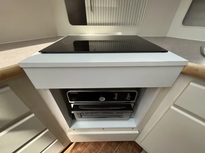  Yacht Photos Pics 1996 Carver 370 Aft Cabin kitchen with stovetop and oven, modern design.