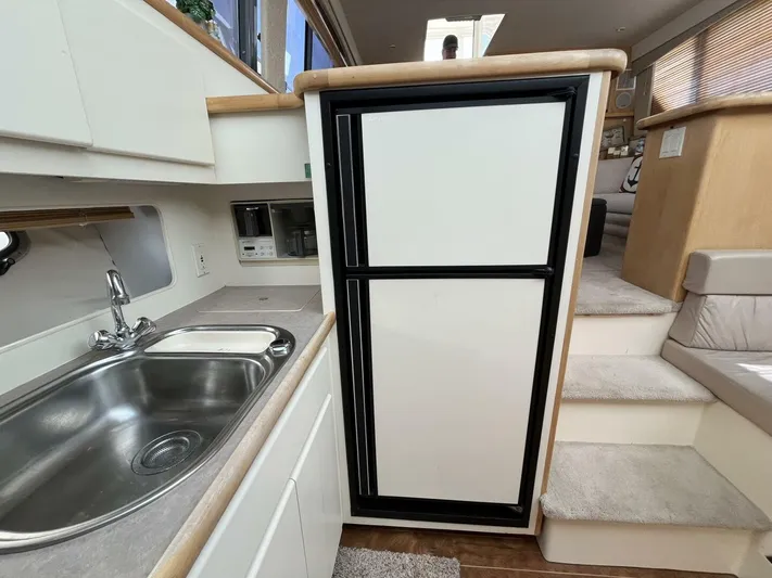  Yacht Photos Pics 1996 Carver 370 Aft Cabin kitchen with sink, refrigerator, and stairs.
