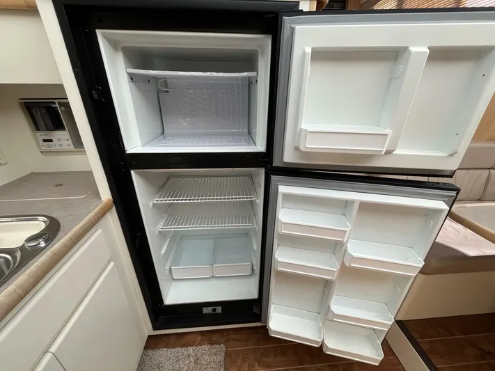  Yacht Photos Pics Refrigerator inside 1996 Carver 370 Aft Cabin yacht, featuring spacious shelves and freezer.