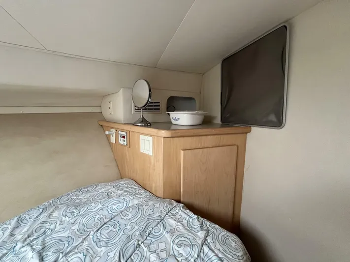  Yacht Photos Pics 1996 Carver 370 Aft Cabin interior with bed, wooden cabinet, and decorative items.