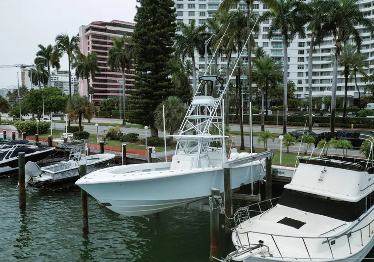  Yacht Photos Pics 2017 SeaVee Z 39 boat docked in a marina with palm trees and buildings in the background.