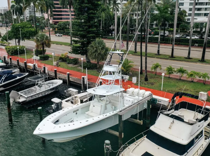  Yacht Photos Pics 2017 SeaVee Z 39 boat docked at marina, surrounded by palm trees and waterfront buildings.