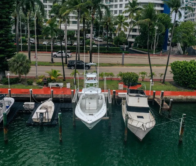  Yacht Photos Pics 2017 SeaVee Z 39 boat docked among other vessels, surrounded by palm trees and waterfront buildings.