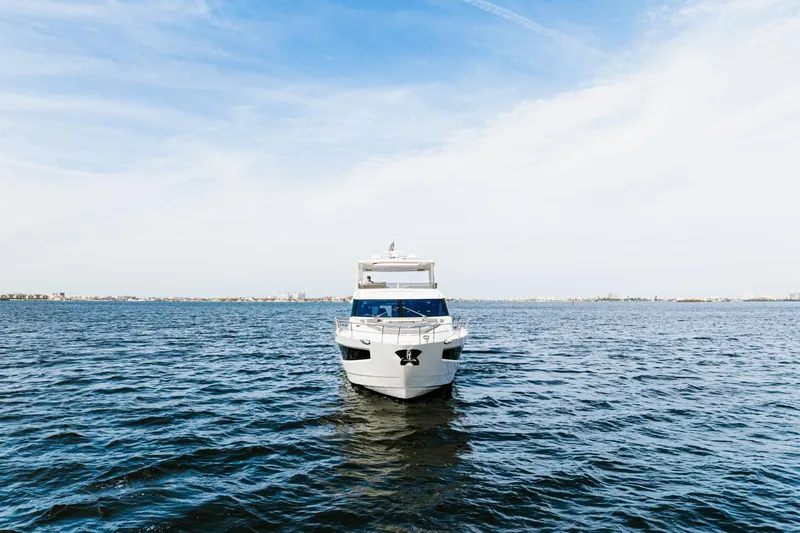 Live More Yacht Photos Pics 2021 Galeon 680 Fly yacht on open water under clear sky.