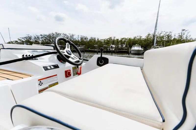 Live More Yacht Photos Pics Interior view of 2021 Galeon 680 Fly yacht with steering wheel and seating.
