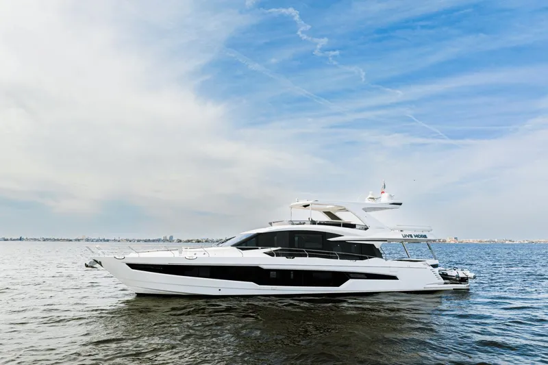 Live More Yacht Photos Pics Luxury 2021 Galeon 680 Fly yacht cruising on open water under a clear sky.