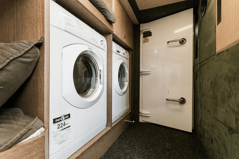 Live More Yacht Photos Pics Laundry area with washing machines inside 2021 Galeon 680 Fly yacht.