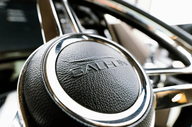 Live More Yacht Photos Pics Close-up of Galeon 680 Fly 2021 steering wheel with logo detail.