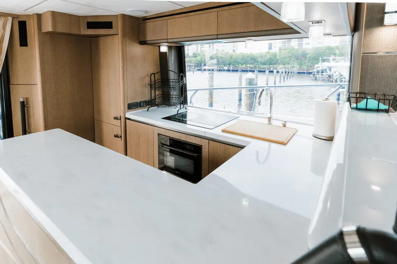 Live More Yacht Photos Pics Modern kitchen interior on 2021 Galeon 680 Fly yacht with waterfront view.