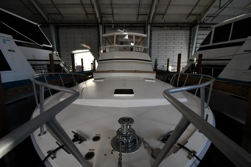 Stormy Yacht Photos Pics 1988 Viking 48 Convertible yacht in storage, showcasing bow and deck details.