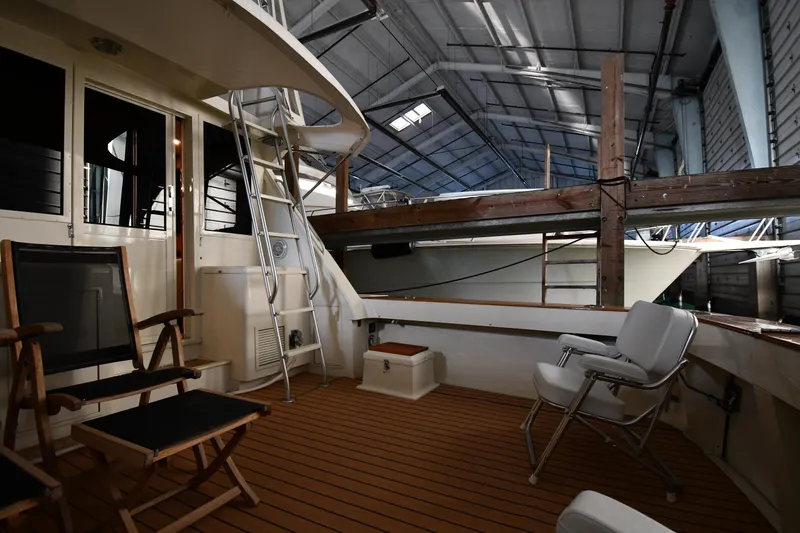 Stormy Yacht Photos Pics 1988 Viking 48 Convertible yacht interior with seating and ladder in a boat shed.