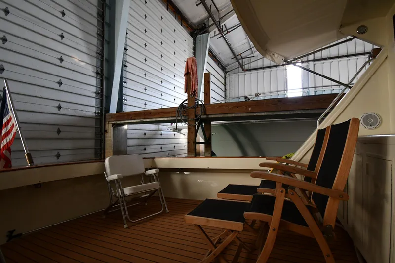 Stormy Yacht Photos Pics 1988 Viking 48 Convertible yacht interior with chairs, docked in a spacious garage.