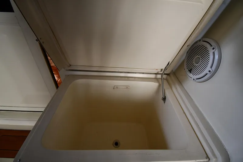 Stormy Yacht Photos Pics Open storage compartment in 1988 Viking 48 Convertible boat interior.