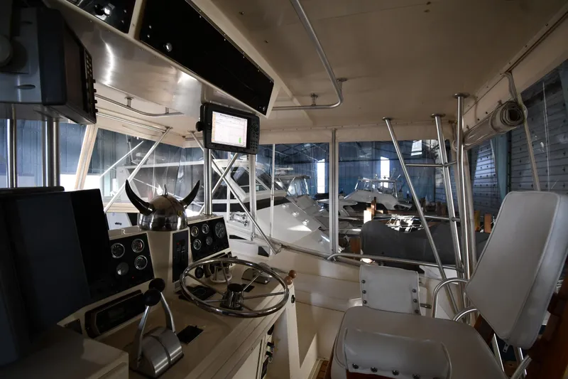Stormy Yacht Photos Pics Interior of 1988 Viking 48 Convertible yacht with steering wheel and navigation equipment.