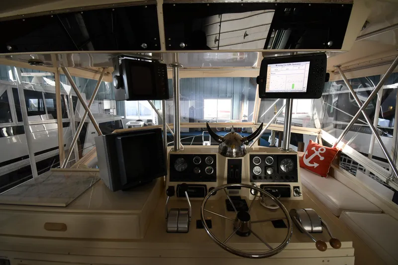Stormy Yacht Photos Pics 1988 Viking 48 Convertible yacht helm with navigation equipment and steering wheel.