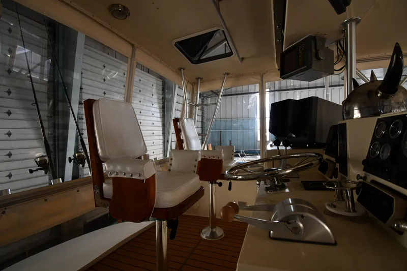 Stormy Yacht Photos Pics Interior of 1988 Viking 48 Convertible yacht with steering wheel and captain's chairs.