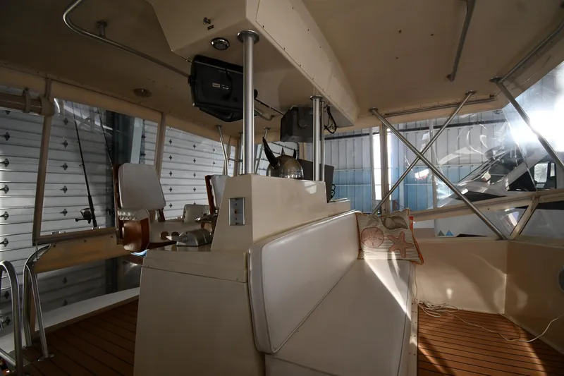 Stormy Yacht Photos Pics Interior of 1988 Viking 48 Convertible yacht with helm and seating area.